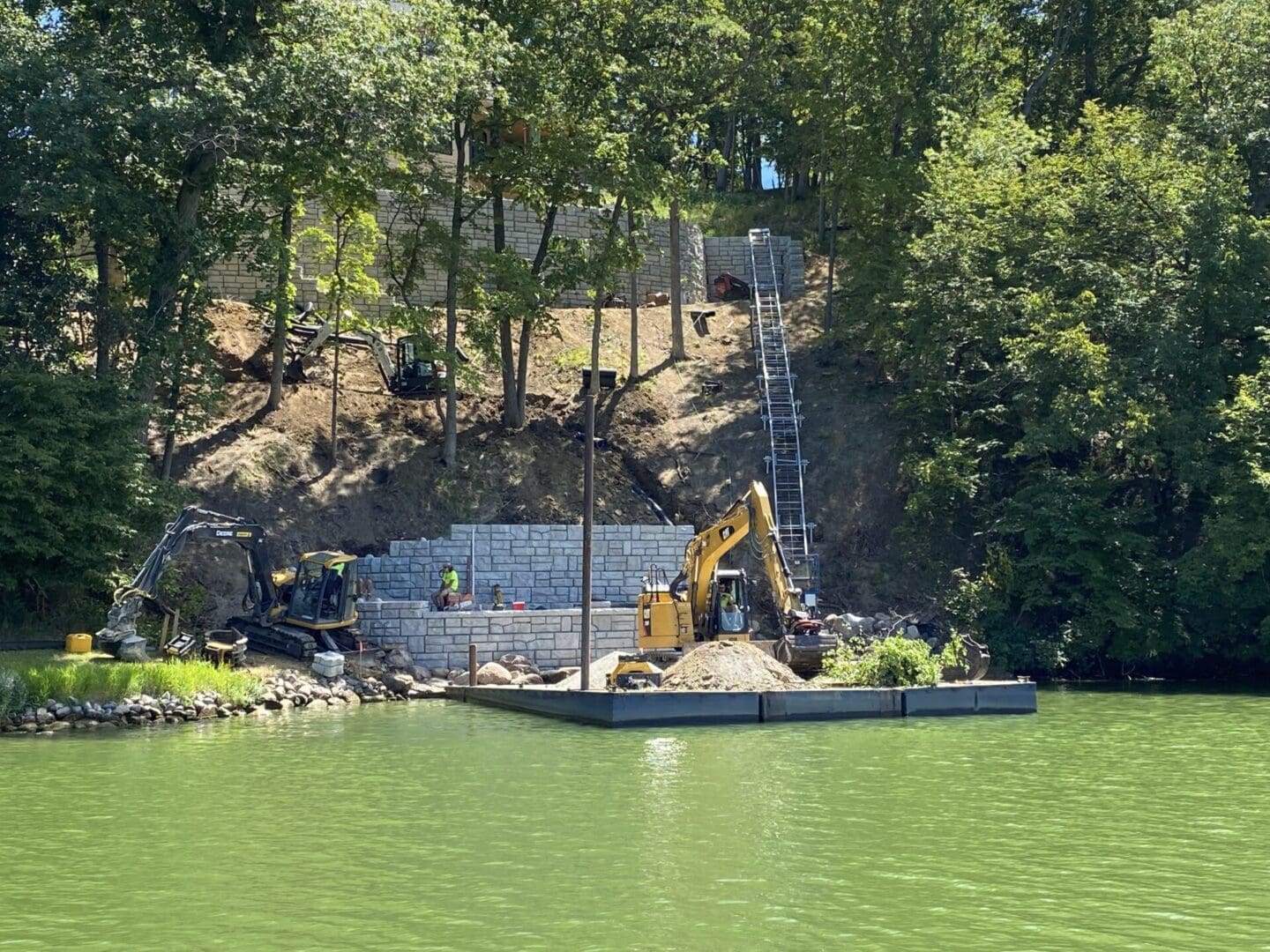 Building a tram to the waters edge with excavator on barge