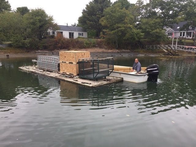 Hillside lift being transported to island project on barge