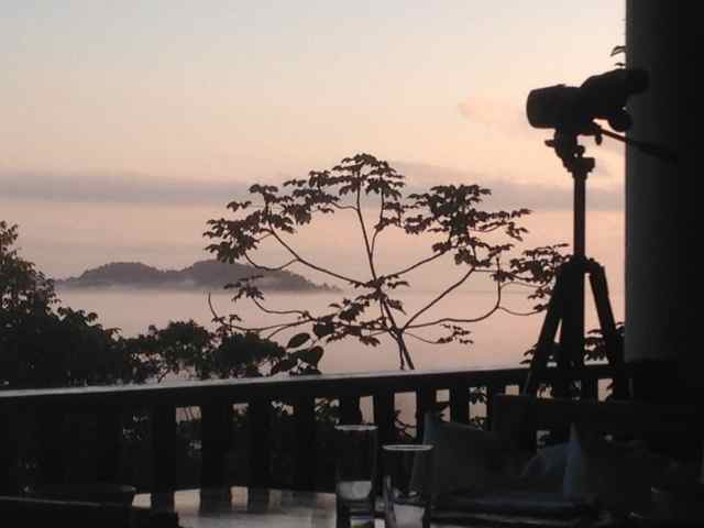 View of fog and mountain tops from dinning area at resort in Belize with two commercial Hill Hiker lifts