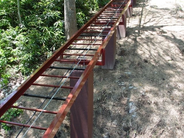 Hill Hiker captured rail mounted with steel brackets to square concrete columns on project in Southwest USA