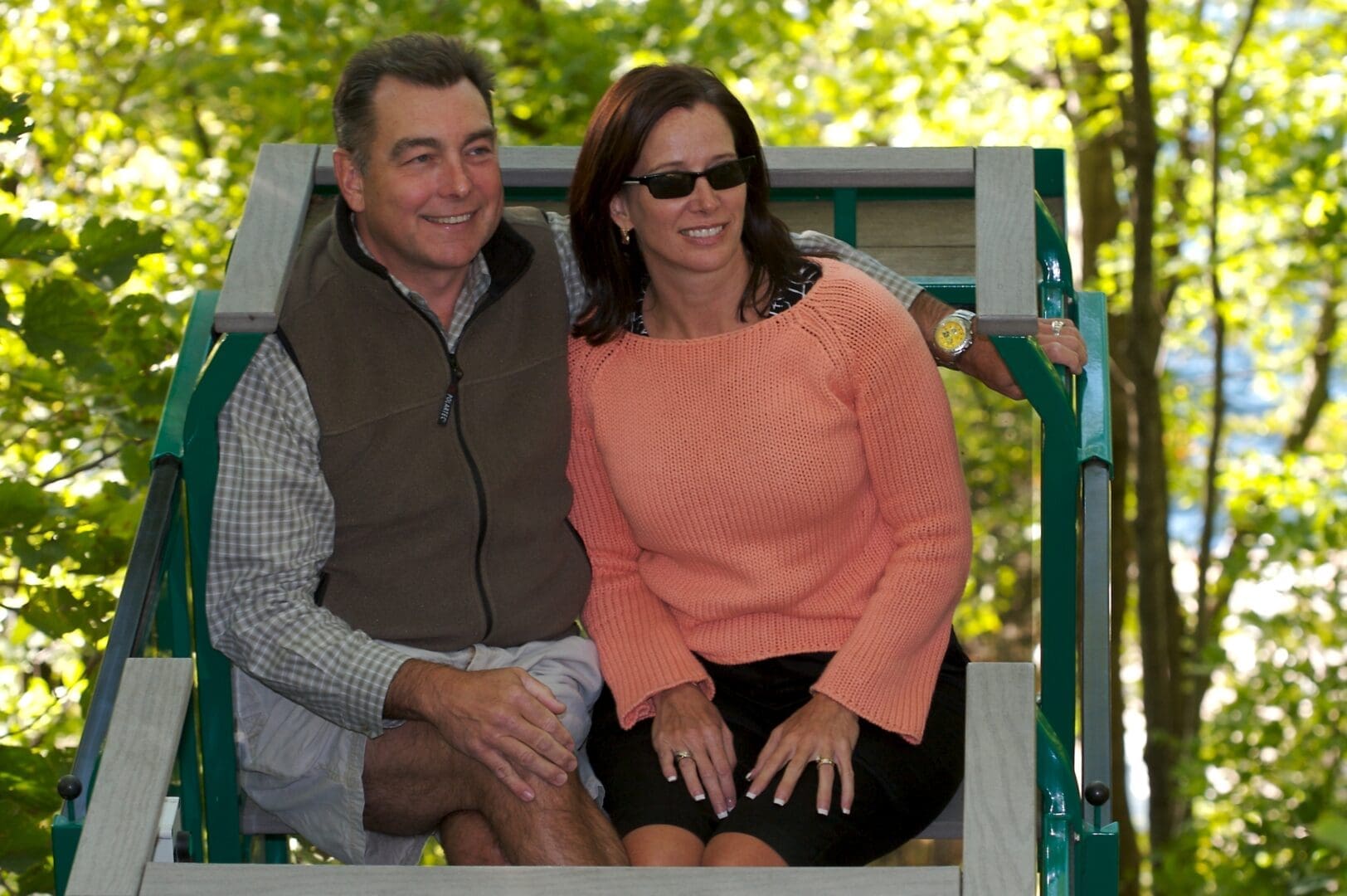 Happy couple rides Hill Hiker outdoor hillside tram