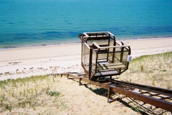 Beautiful sand beach with blue ocean water with access provided by beach incline elevator lift