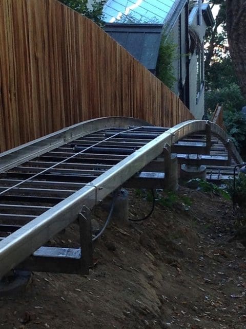 Hill Hiker curved stainless steel track rail on concrete column piers