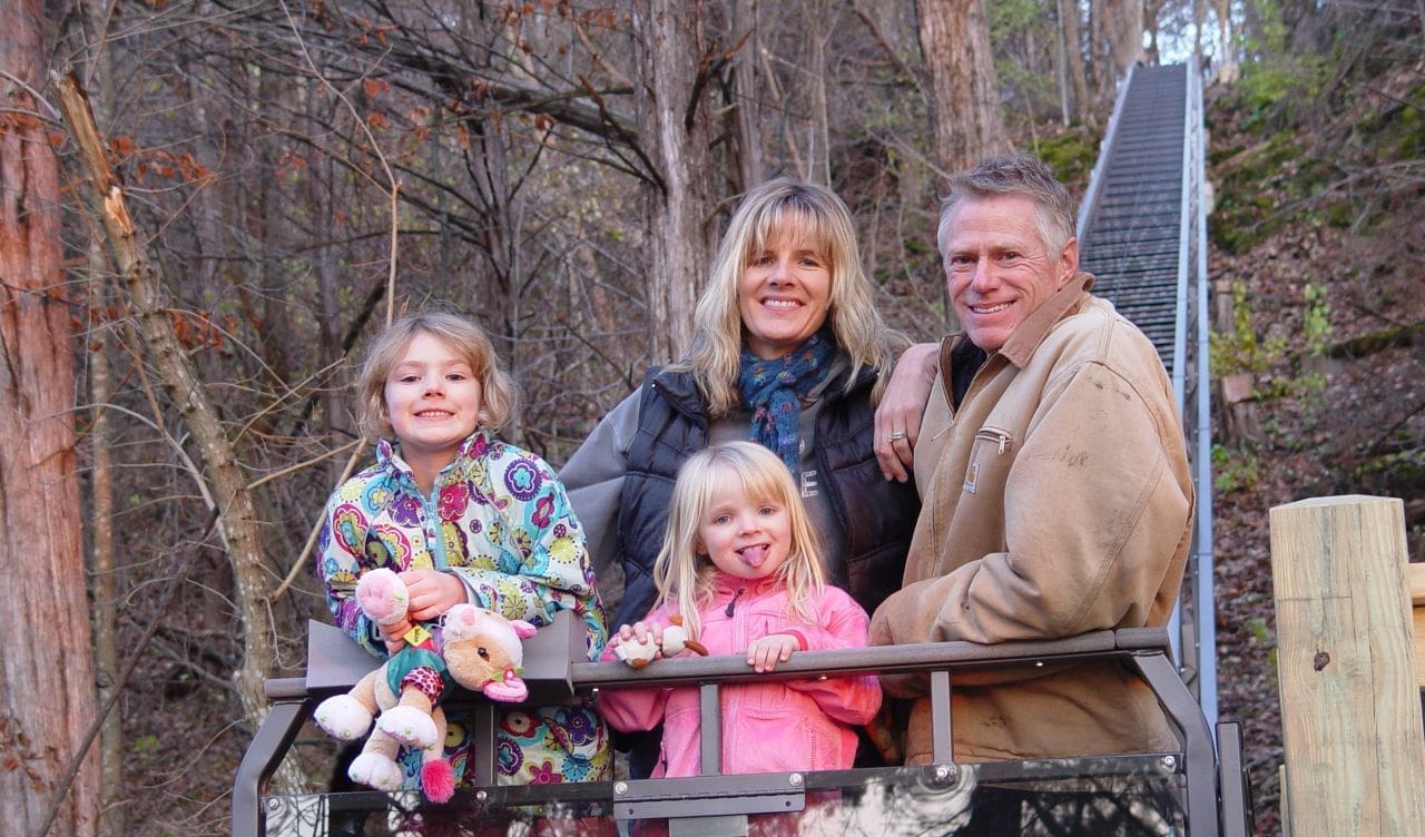 Happy young family aboard their Hill Hiker Hill Elevator Tram