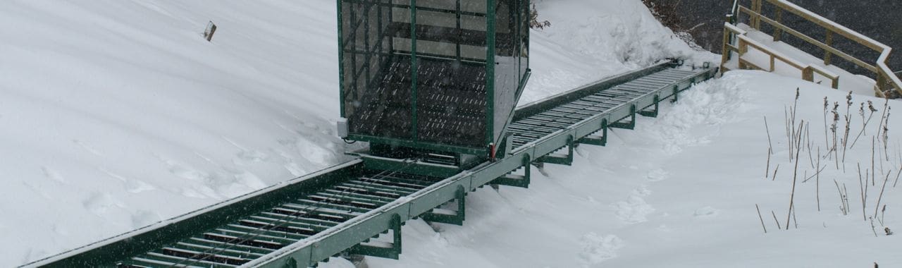 Commercial industrial outdoor incline elevator operating in winter